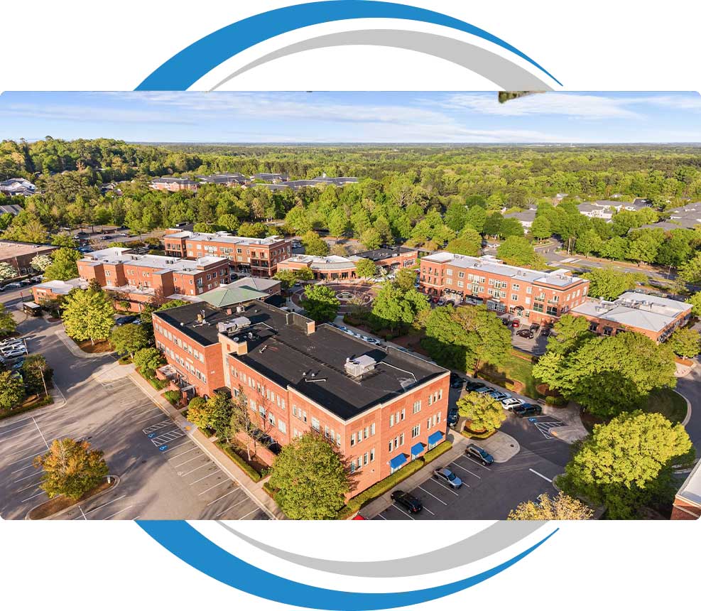 Aerial view of the brick dental office building and Meadowmont Village complex — Meadowmont Dentistry in Chapel Hill, NC