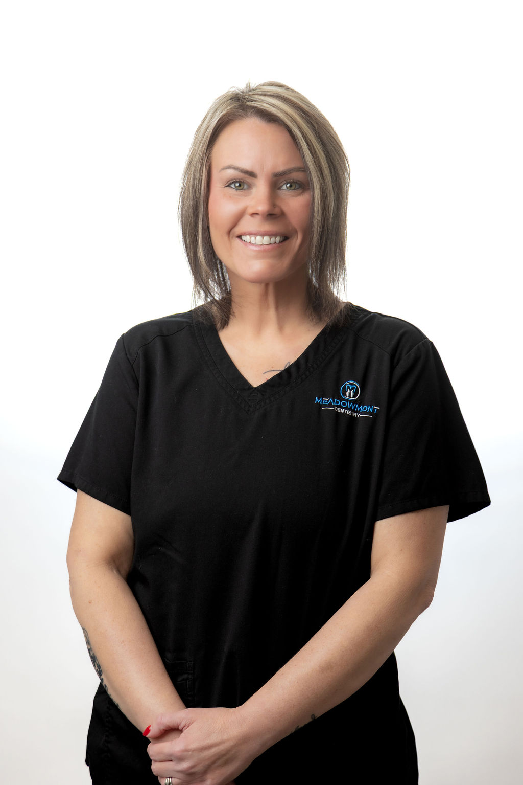 Headshot of a female staff member with a blonde bob in black scrubs — Meadowmont Dentistry in Chapel Hill, NC