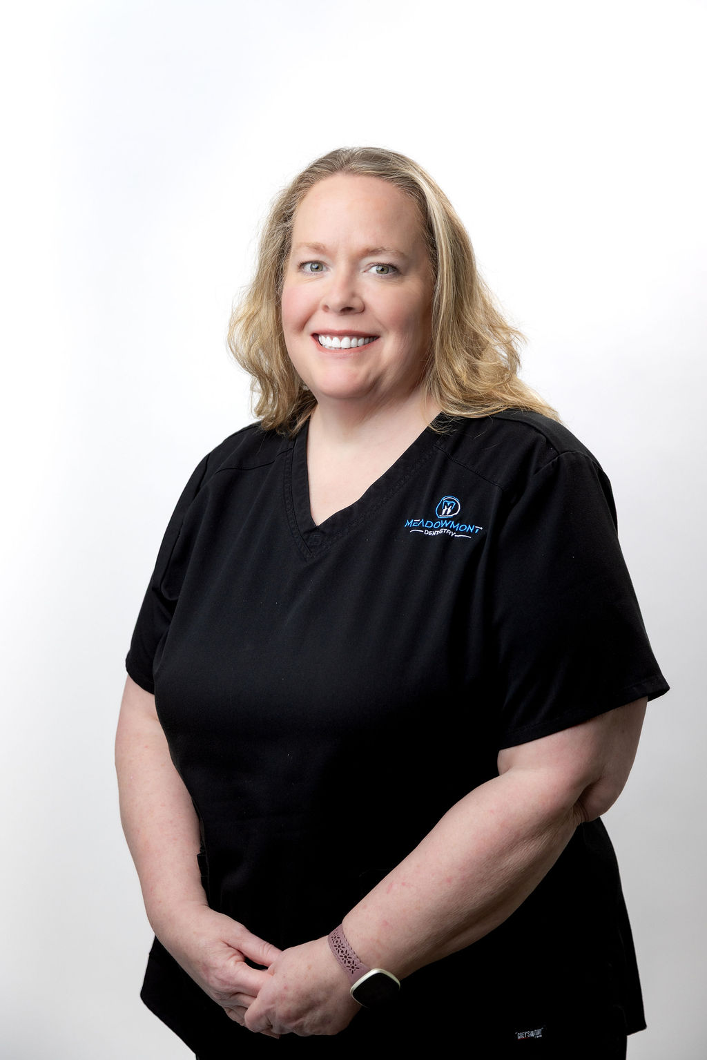 Headshot of a female staff member with a blonde bob in black scrubs — Meadowmont Dentistry in Chapel Hill, NC